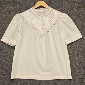 White short-sleeved blouse with a round neckline and lace detailing